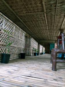 a room with a bench and potted plants at Risong Family Guest House in Majuli
