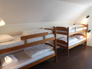 a room with three bunk beds with white towels at Trysunda Vandrarhem & Skärgårdscafé 