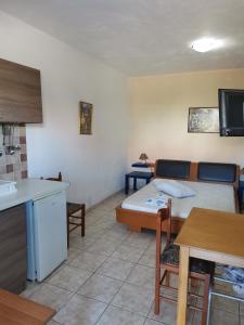 a room with a bed and a kitchen with a sink at Mylos Garden in Livadi +54 photos