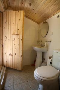 a bathroom with a toilet and a sink at Hane-i Keyif Pension in Cıralı