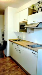 a white kitchen with a sink and a stove at Saar-Mosel-Tal in Konz