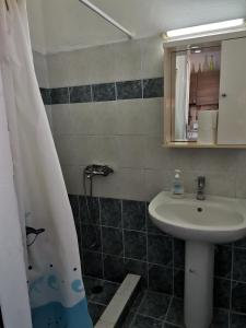 a bathroom with a sink and a shower at Mylos Garden in Livadi