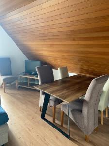 a dining room with a wooden table and chairs at Panorama Point in Sasbachwalden