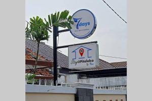 a sign for a shop on top of a building at Stay@Pitaloka in Cirebon