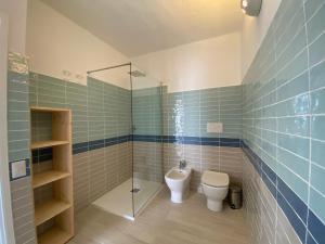 a bathroom with a toilet and a glass shower at Appartamento in Costa Smeralda - Bilocale sul mare - Sea View in Olbia +5 photos