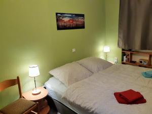 a bedroom with a bed and two lamps and a chair at Ferienwohnung Petronela in Waren