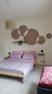 Posteľ alebo postele v izbe v ubytovaní Casa vacanze Ombretta