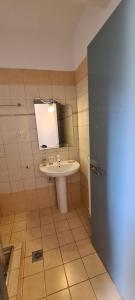 a bathroom with a sink and a mirror at Villa Keramidi in Limenaria