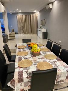 a table with bananas and a bowl of fruit on it at SALY - Villa Kage 6 chambres -Clim-Wifi-Eau chaude-Billard-Babyfoot-Ping pong-Canal - ELECTRICITE NON COMPRISE in Sali Nianiaral