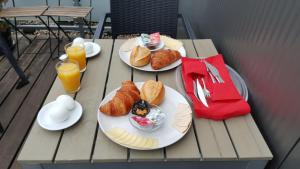 two plates of croissants and orange juice on a table at Art Rock Downtown Hotel in Cologne