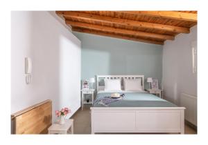 a bedroom with a bed in a white room at Baulus Yard Luxury I in Heraklio Town