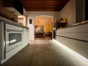 a kitchen with white appliances and a dining room at The Villetta in Petershausen +13 photos