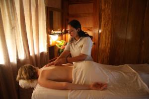 a woman in a white dress sitting on a bed at St. George's Caye Resort in Ladyville
