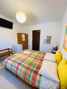 a bedroom with a bed with a colorful blanket at Eucalipto in Faro