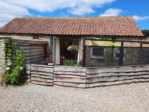 a house with a wooden deck in front of it at Larch Cottage, Ruston dog friendly with hot tub in Scarborough