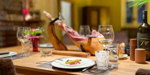 a table with a plate of food and wine glasses at The Villetta in Petershausen