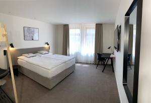 Posteľ alebo postele v izbe v ubytovaní Rozmaryn Hotel B&B