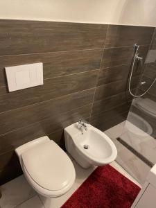 a bathroom with a white toilet and a sink at Mory&Clary Cave Palese Airport in Bari Palese