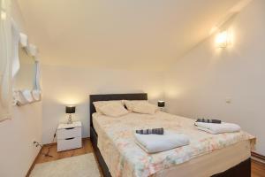 a small bedroom with a bed with two pillows at Agriculture & Holiday house Lasko in Goveđari