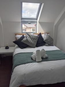 a bedroom with a bed with a stuffed animal on it at Central Apartment Newcastle in Newcastle