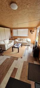 a living room with a couch and a coffee table at Scent yard in Marijampolė