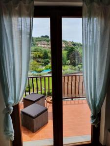 a view of a balcony from a glass door at la casa del pittore Anna house in Lerici