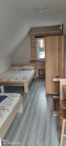 A bed or beds in a room at Sielski Zakątek domki