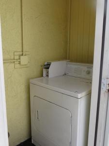 a white washer and dryer in a room at Lemon Tree Inn in Naples