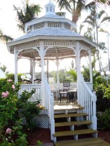 a white gazebo with a table and chairs at Lemon Tree Inn in Naples