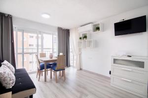 a living room with a table and a dining room at virginia-48 in Benidorm