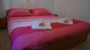 a bedroom with a bed with two towels on it at Apartment Rosanna - Intermezzo in center of Rabac in Rabac