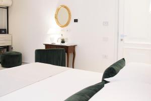 a bedroom with a bed and a mirror on the wall at Tenuta Tropeano in Tropea