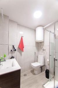 a white bathroom with a toilet and a sink at virginia-48 in Benidorm