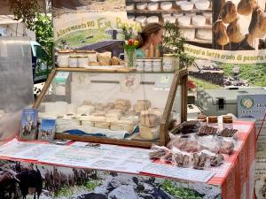 a woman standing in front of a food stand at BB Palazzo Doria in Dolcedo