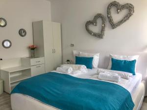 um quarto com uma cama grande com dois corações na parede em Gizell Apartment 1 em Sibiu