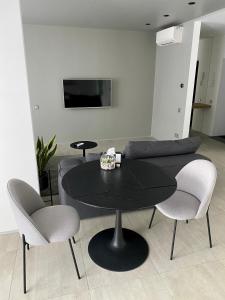 a black table and chairs in a living room at Caсtus Apartments 1 in Ivano-Frankivsk