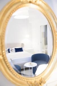a bedroom with a bed and a table in a mirror at Tenuta Tropeano in Tropea