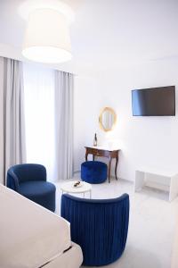 a hotel room with a bed and two chairs and a table at Tenuta Tropeano in Tropea