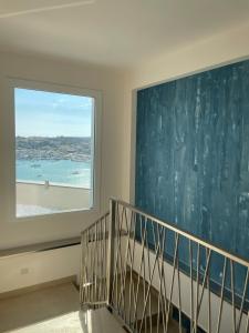 a staircase with a large window in a house at B&B Giro Di Boa in Lampedusa