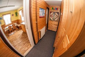 a hallway of a house with wooden walls and a mirror at Penzion 358 in Vrchlabí