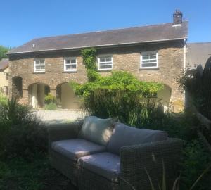 a couch in front of a brick house at The Mews, Talley in Llandeilo