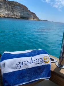 a towel sitting on the side of a boat in the water at B&B Giro Di Boa in Lampedusa