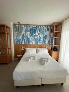 a bedroom with a bed with towels on it at B&B Giro Di Boa in Lampedusa