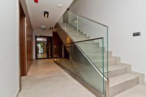 a glass staircase in a house at BlueApart Apartland Residence in Jastarnia