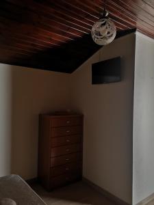 a bedroom with a wooden ceiling and a dresser at Casa Girão - Alojamento Local in Termas de Sao Pedro do Sul