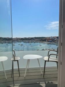 a balcony with two chairs and a table and a view at B&B Giro Di Boa in Lampedusa