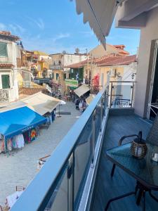 a balcony with a table and a view of a city at Dim House in Parga
