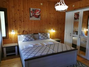 a bedroom with a bed in a room with wooden walls at The Old House in Nesebar
