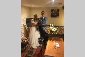 a bride and groom posing for a picture in a room at The Byre (Unusual and Different). in Dromore