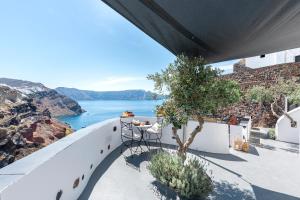 a balcony with a view of the water at Pearl of Caldera Oia - Boutique Hotel by Pearl Hotel Collection in Oia
